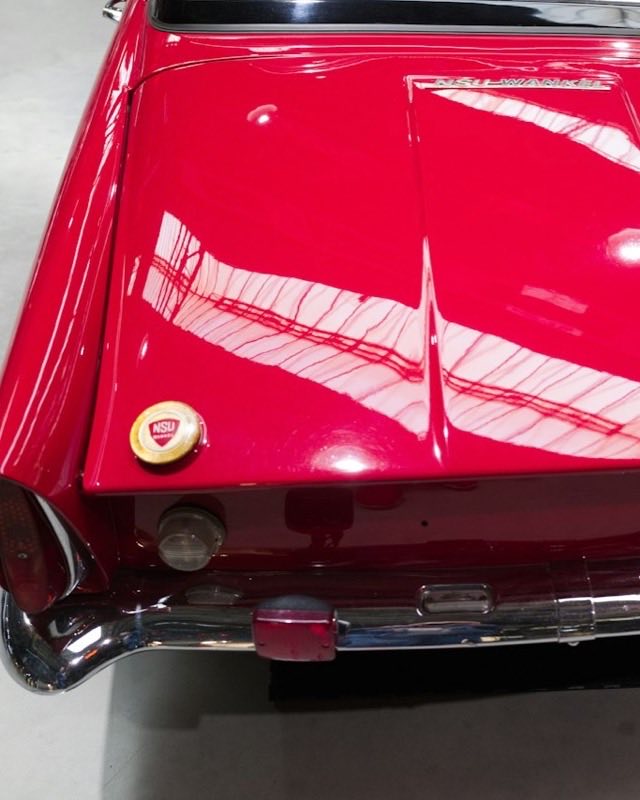 The red rear deck of an NSU Wankel Spider, its NSU-Wankel script badge above a chrome bumper and a fuel cap carrying the NSU roundel